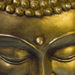 Golden Buddah face. Closeup. Selective focus.